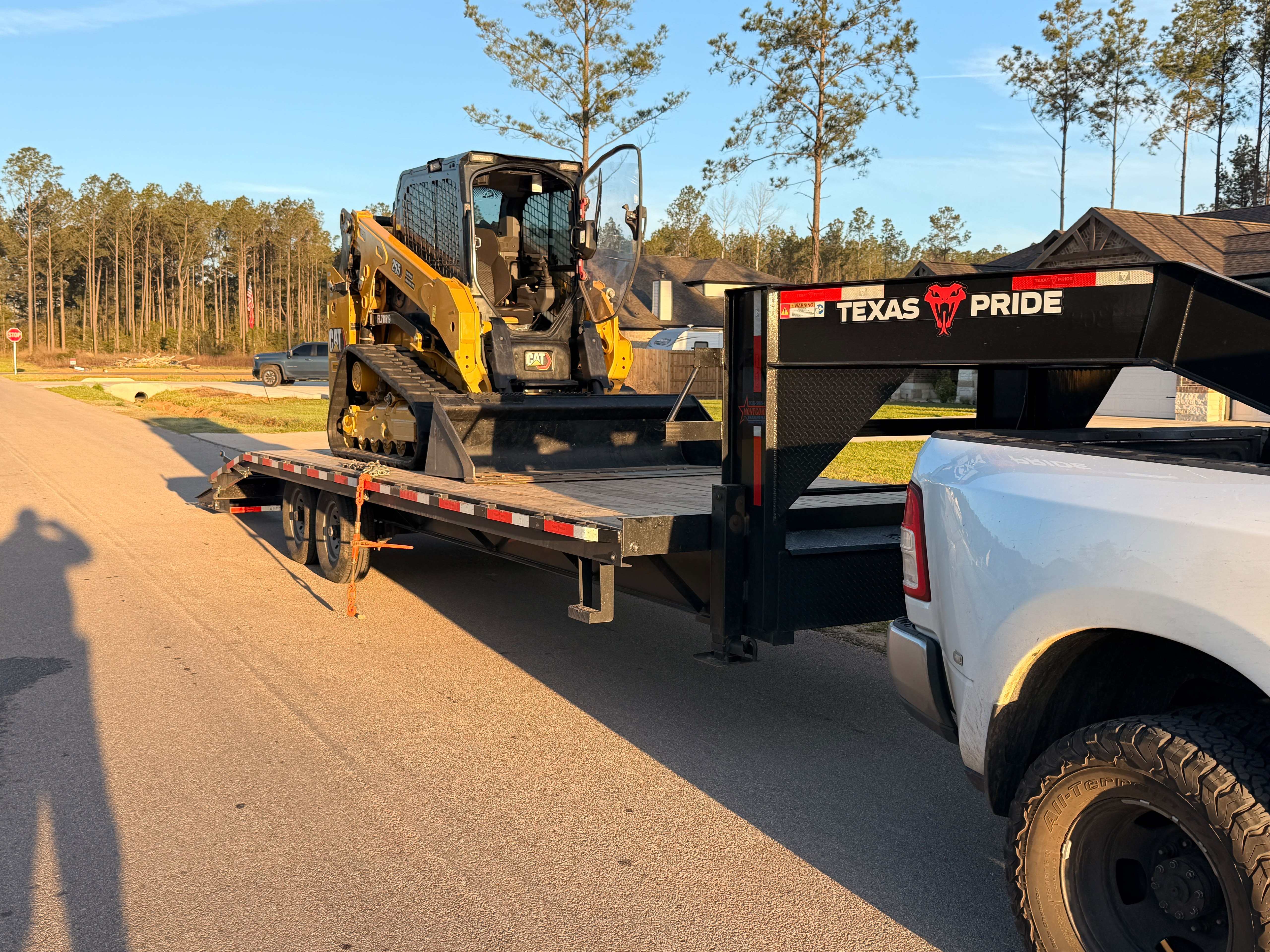 120+ HP high-flow commercial forestry mulcher clearing land at golden hour in Montgomery County, TX